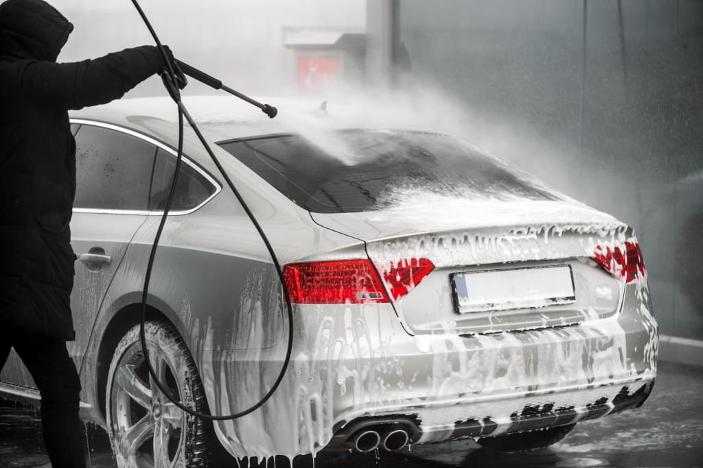 man-washing-his-grey-car-high-pressure-water-outdoors-back-view.jpg