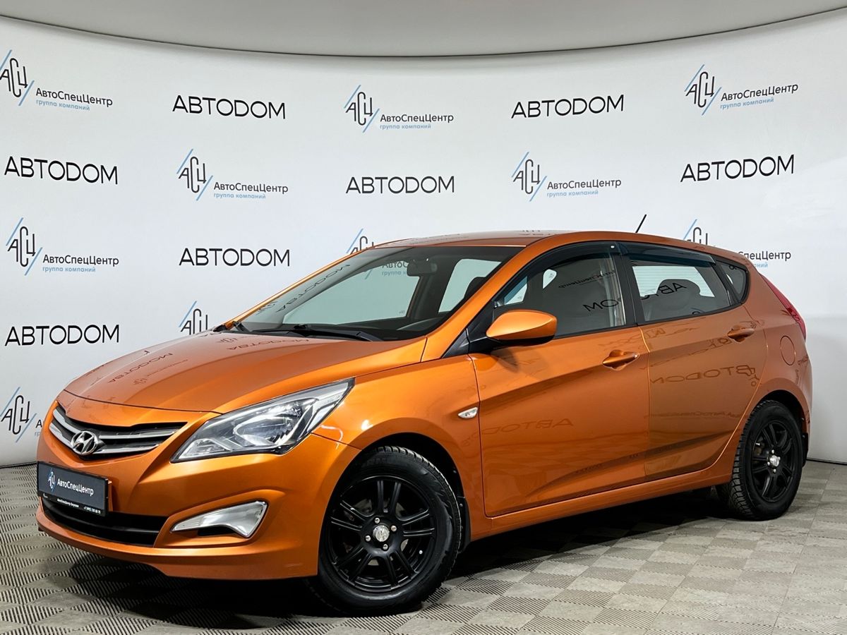 Автомобиль Hyundai Solaris I [рестайлинг] 1.4 AT (107 л.с.) Comfort Оранжевый 2016 с пробегом 140 668 км